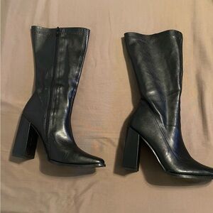 Mid-calf black boots. Excellent condition.